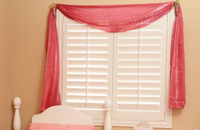 Girl's room with plantation shutters.